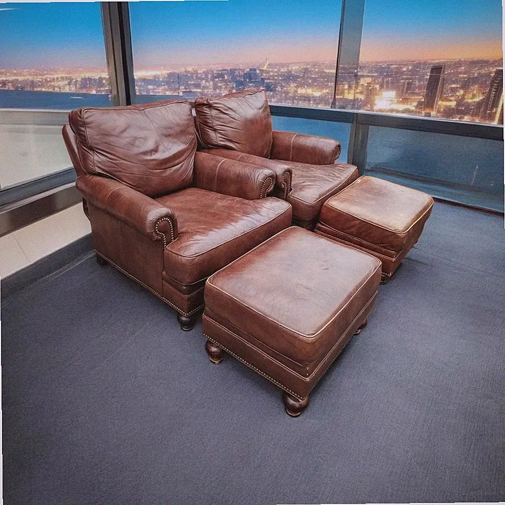 A Pair of Bradington Young reclining leather club chairs and matching ottomans